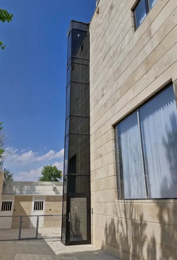 Outdoor glass home lift installed on modern residential building
